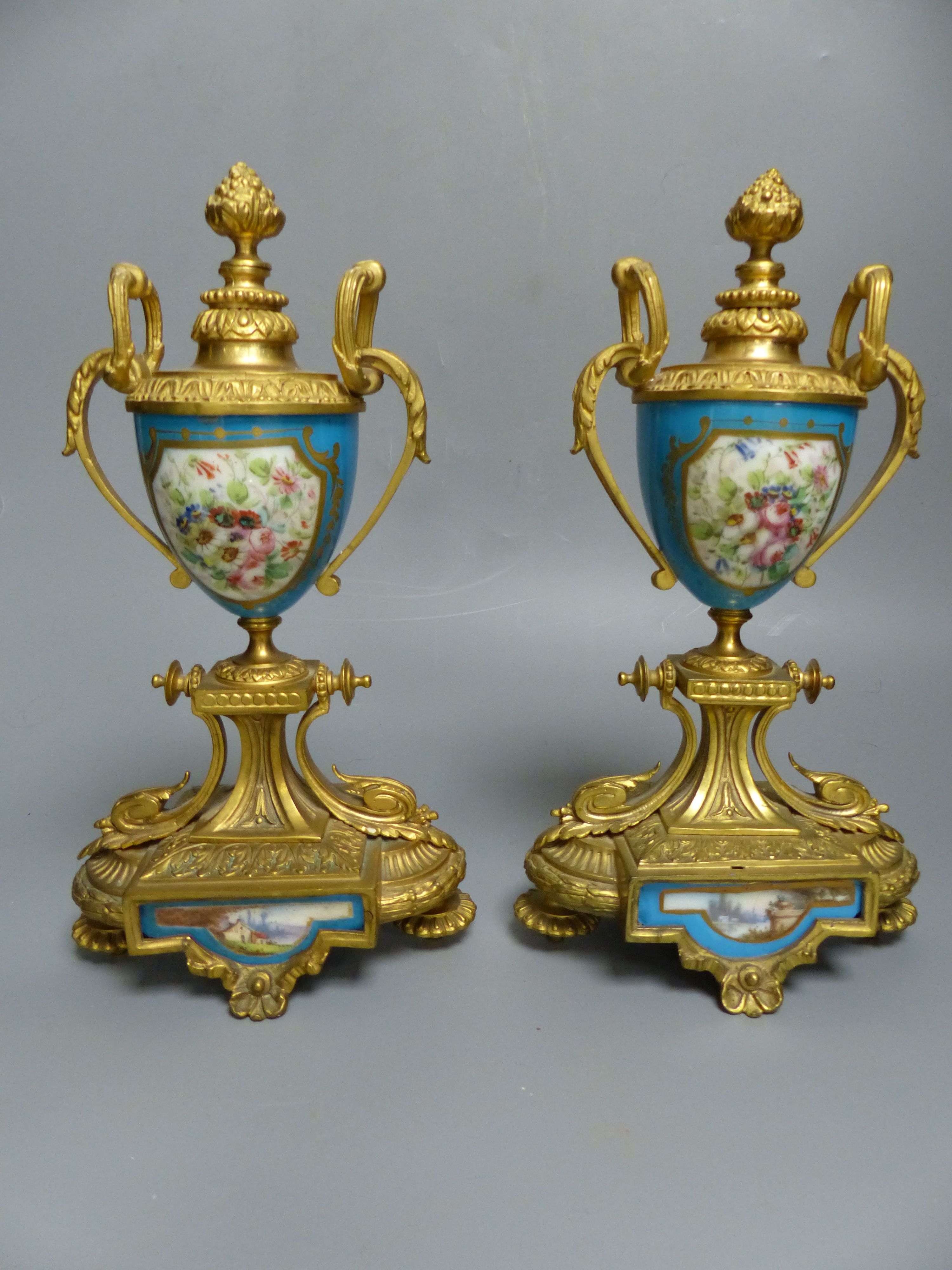 A pair of 19th century French ormolu and Sevres style porcelain urns, decorated with flowers and landscapes, height 26.5cm